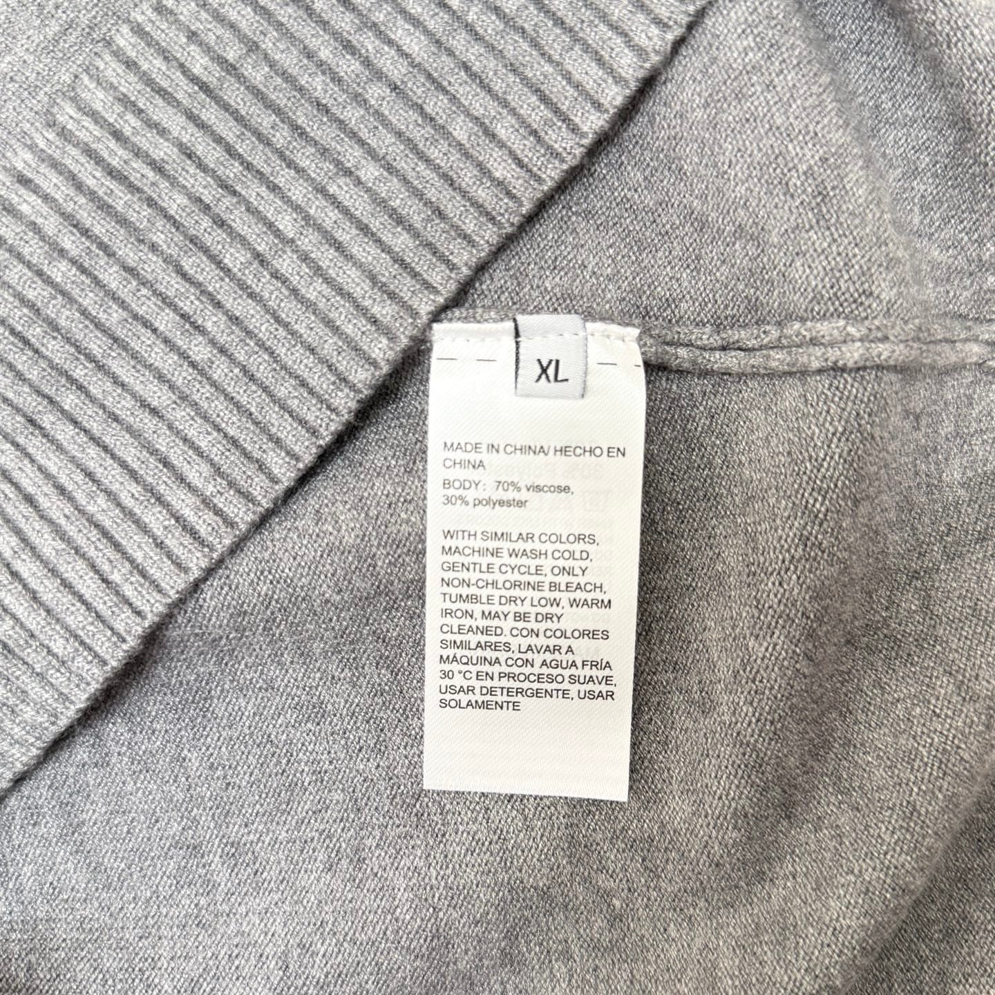 Size XL care label on gray knit sweater
