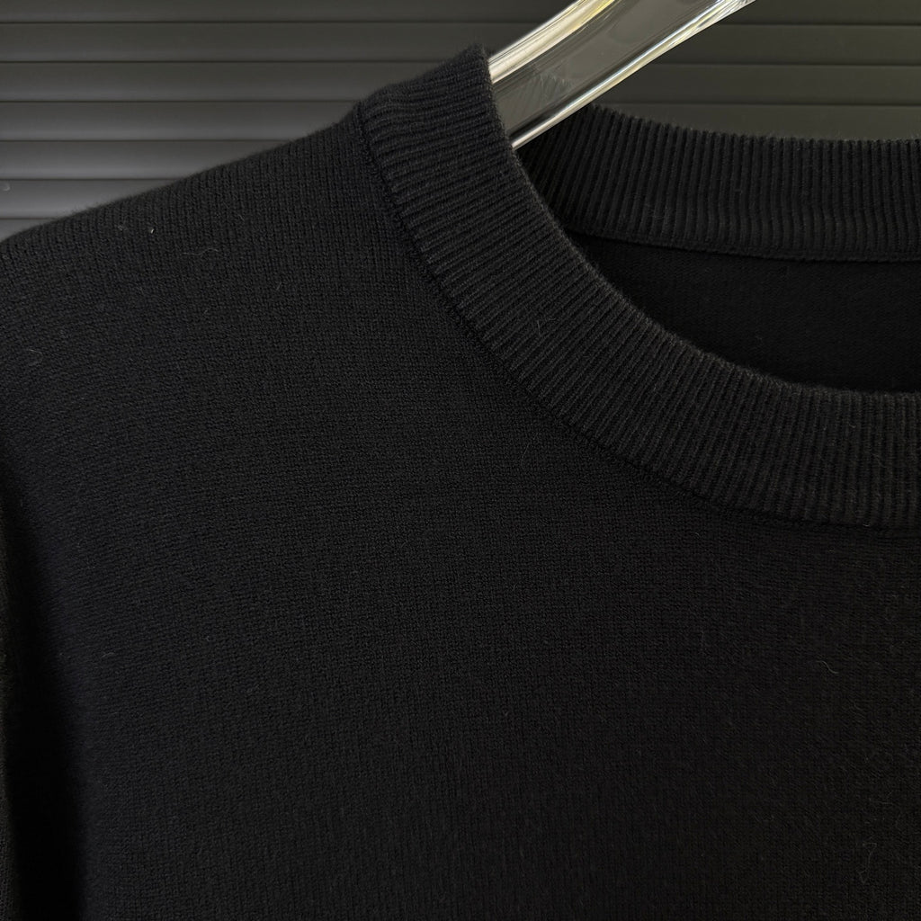 Black Moncler sweater shoulder with ribbed knit collar and smooth knit body