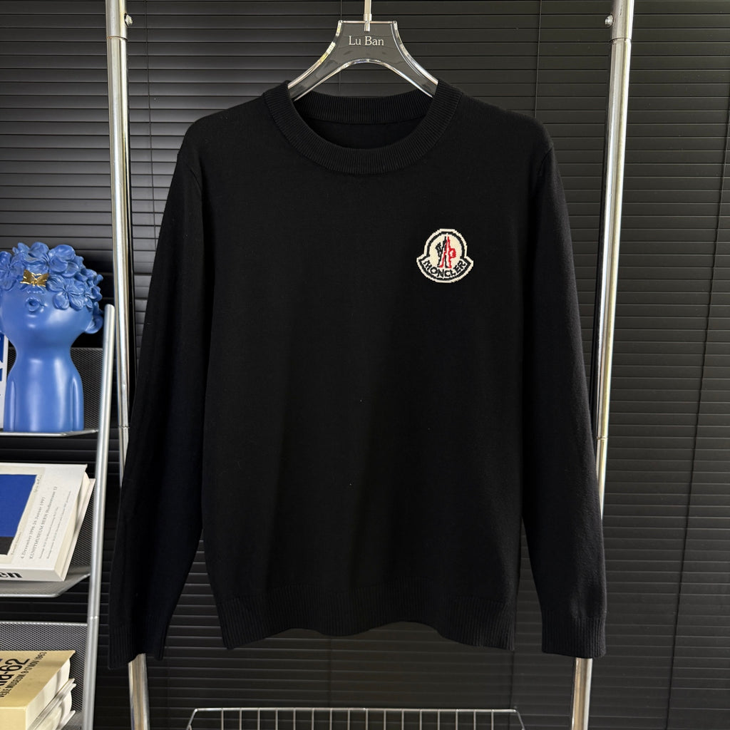 Black Moncler long-sleeve sweater with crew neck and chest logo patch