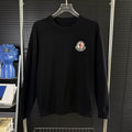 Black Moncler long-sleeve sweater with crew neck and chest logo patch