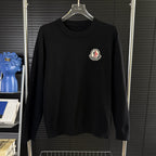 Black Moncler long-sleeve sweater with crew neck and chest logo patch