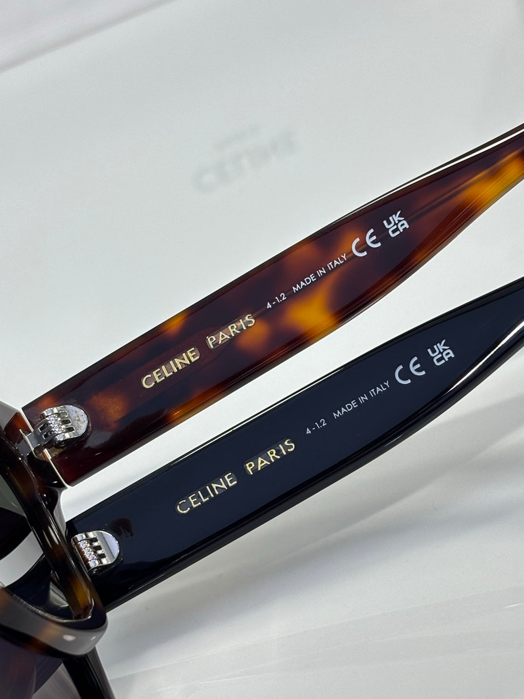 Celine sunglasses close-up: engraved “CELINE PARIS” on blue temple, tortoise trim