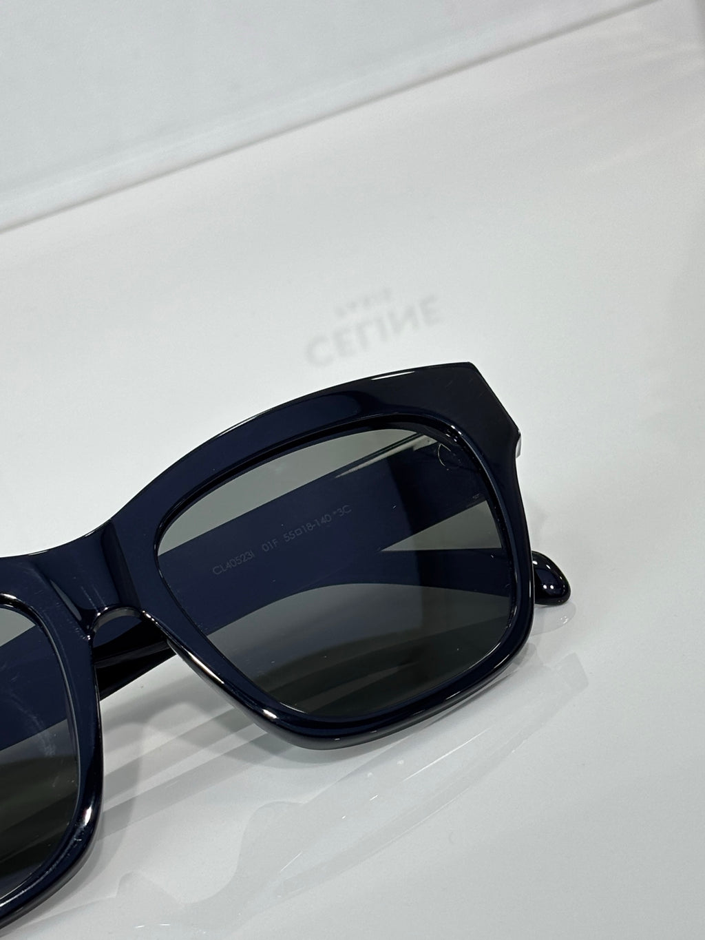 Celine sunglasses close-up with dark navy frames and dark tinted lenses