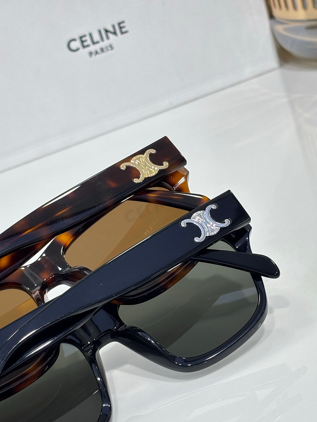 Celine sunglasses close-up with two-tone frames, gold hinge detail, dark lenses