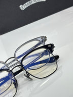 Close-up of chrome eyeglass frame with blue lens sections and metal hinge