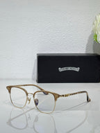 Chrome eyeglasses with gold rectangular frames and clear lenses, angled side view