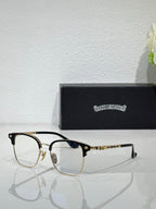 Chrome eyeglasses with gold-tone frames, clear lenses, and blue temple accents