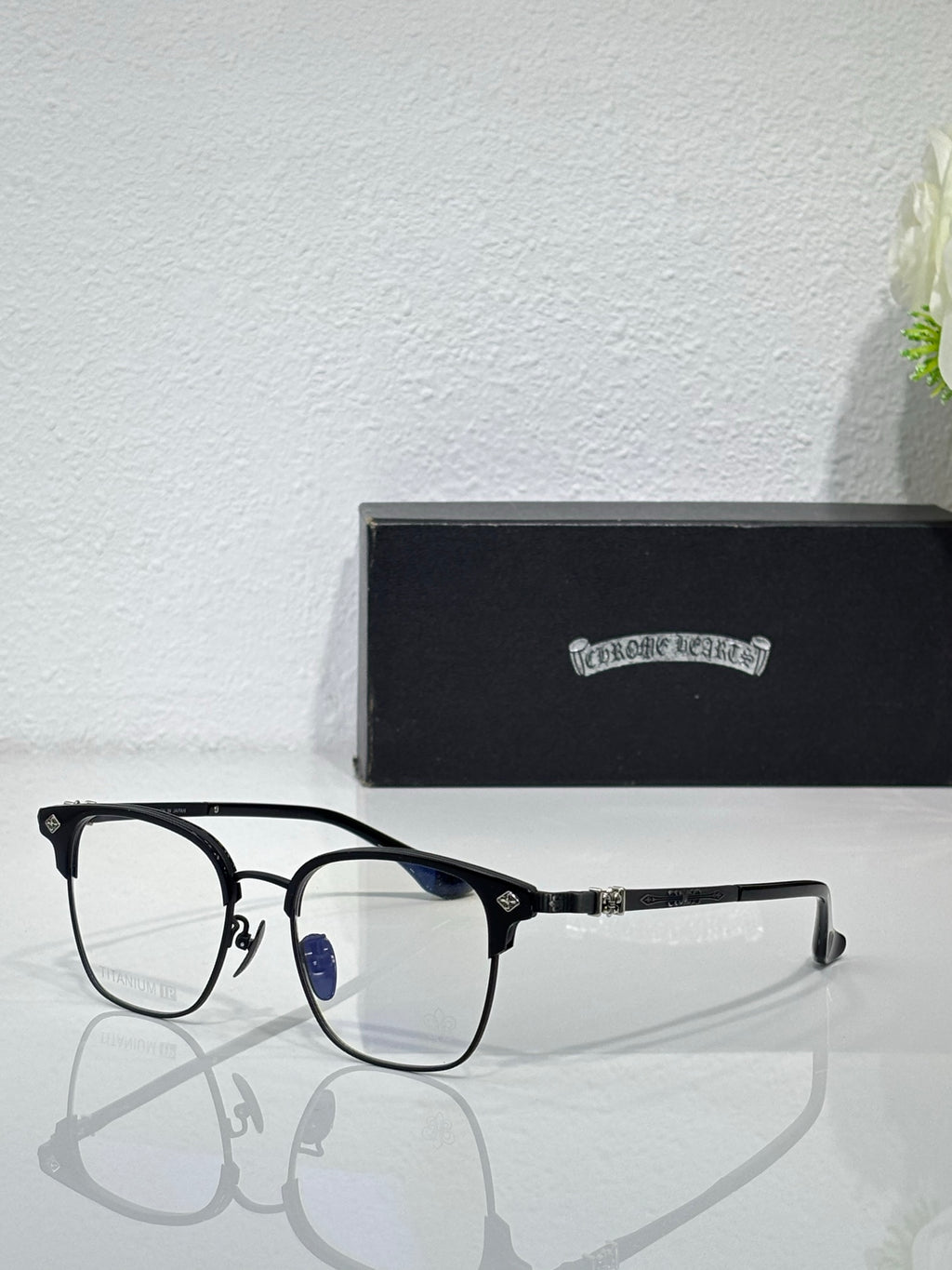 Chrome eyeglasses with black frames and clear lenses, front and side hinge detail