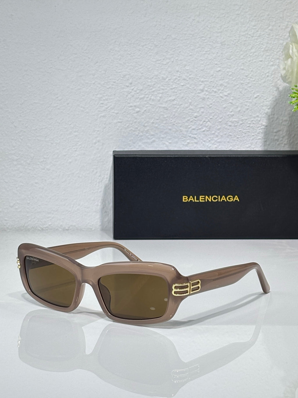 Balenciaga sunglasses with taupe-brown frames and brown lenses, gold logo on temples