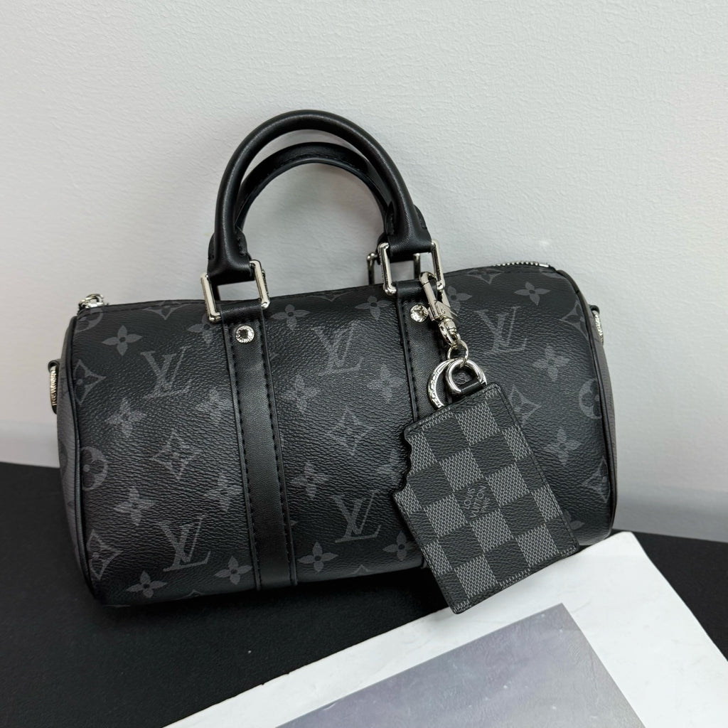 Louis Vuitton monogram handbag with black handles and detachable gray checker keychain card