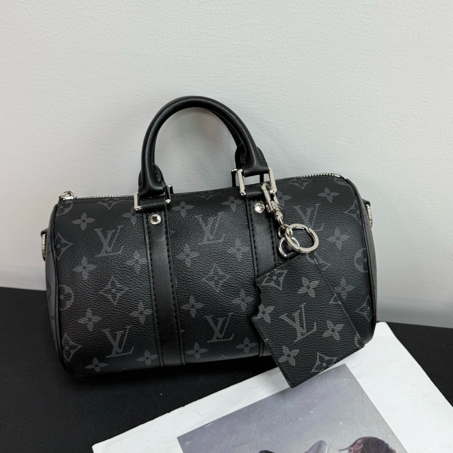 Louis Vuitton monogram handbag with attached dark pouch keychain and metal hardware