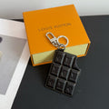 Louis Vuitton key holder with black quilted panels and logo charms