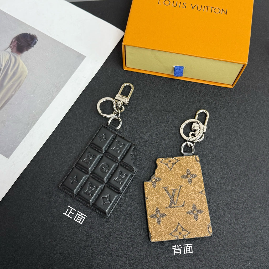 Louis Vuitton keychain charm with black and tan monogram card and silver clasp