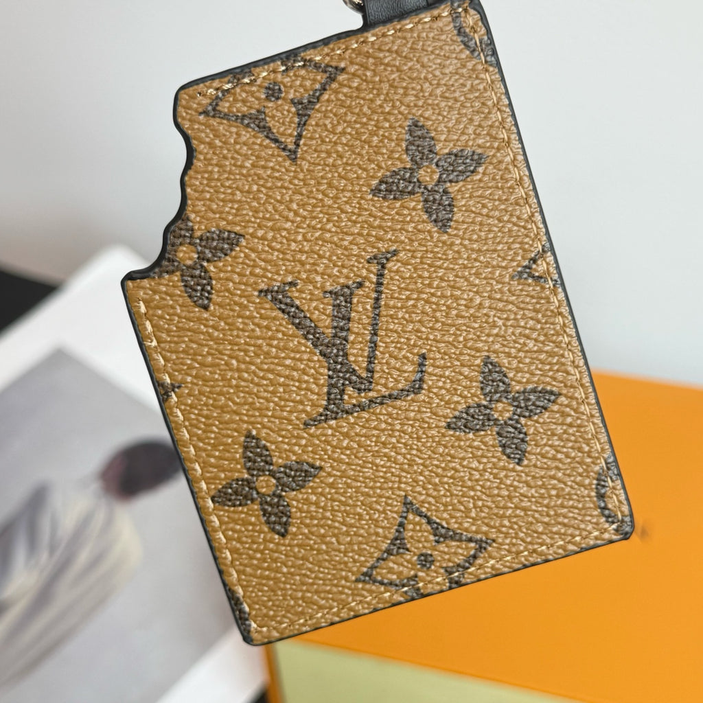 Louis Vuitton key holder with tan monogram print and stitched scalloped edge