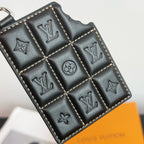 Louis Vuitton key holder close-up with embossed LV symbols and diamond quilting
