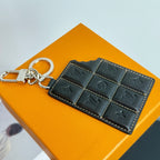Louis Vuitton key holder in dark leather with stitch pattern and keyring