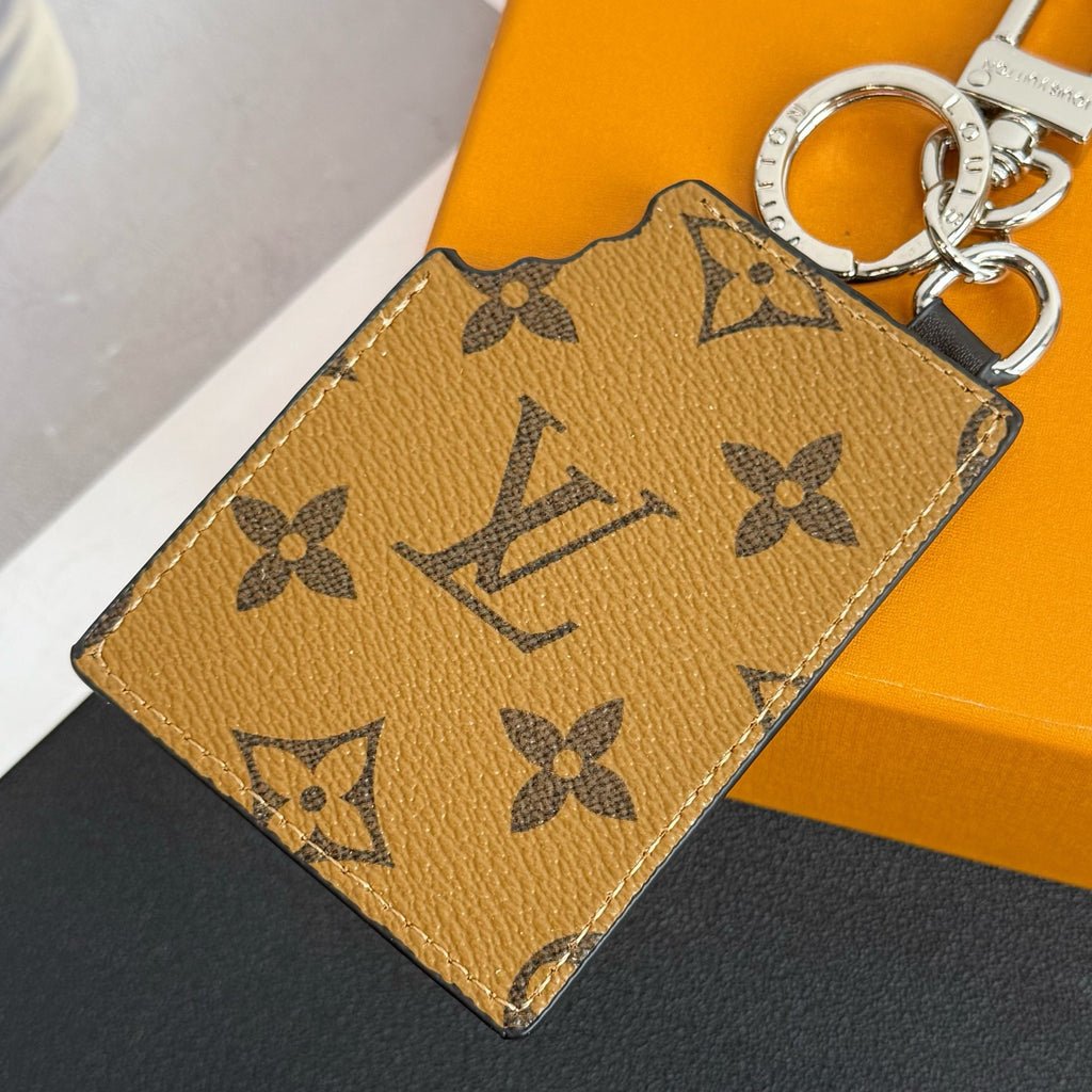 Louis Vuitton key holder with tan monogram print and metal keyring