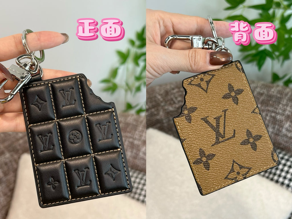 Louis Vuitton key holder with black quilted panels and metal keyring clasp