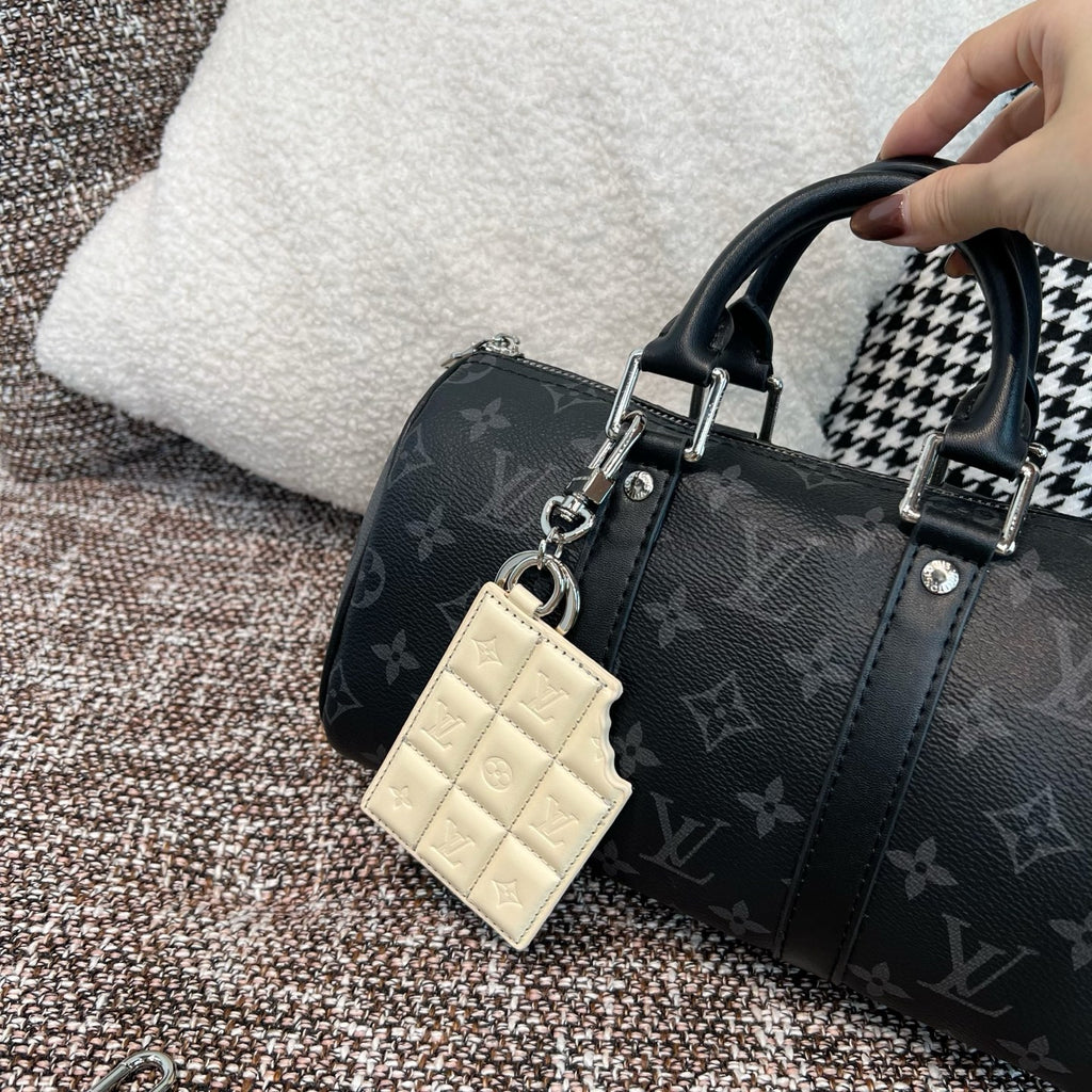 Louis Vuitton monogram handbag with cream leather key holder charm and hanging tag