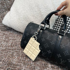 Louis Vuitton monogram handbag with cream leather key holder charm and hanging tag