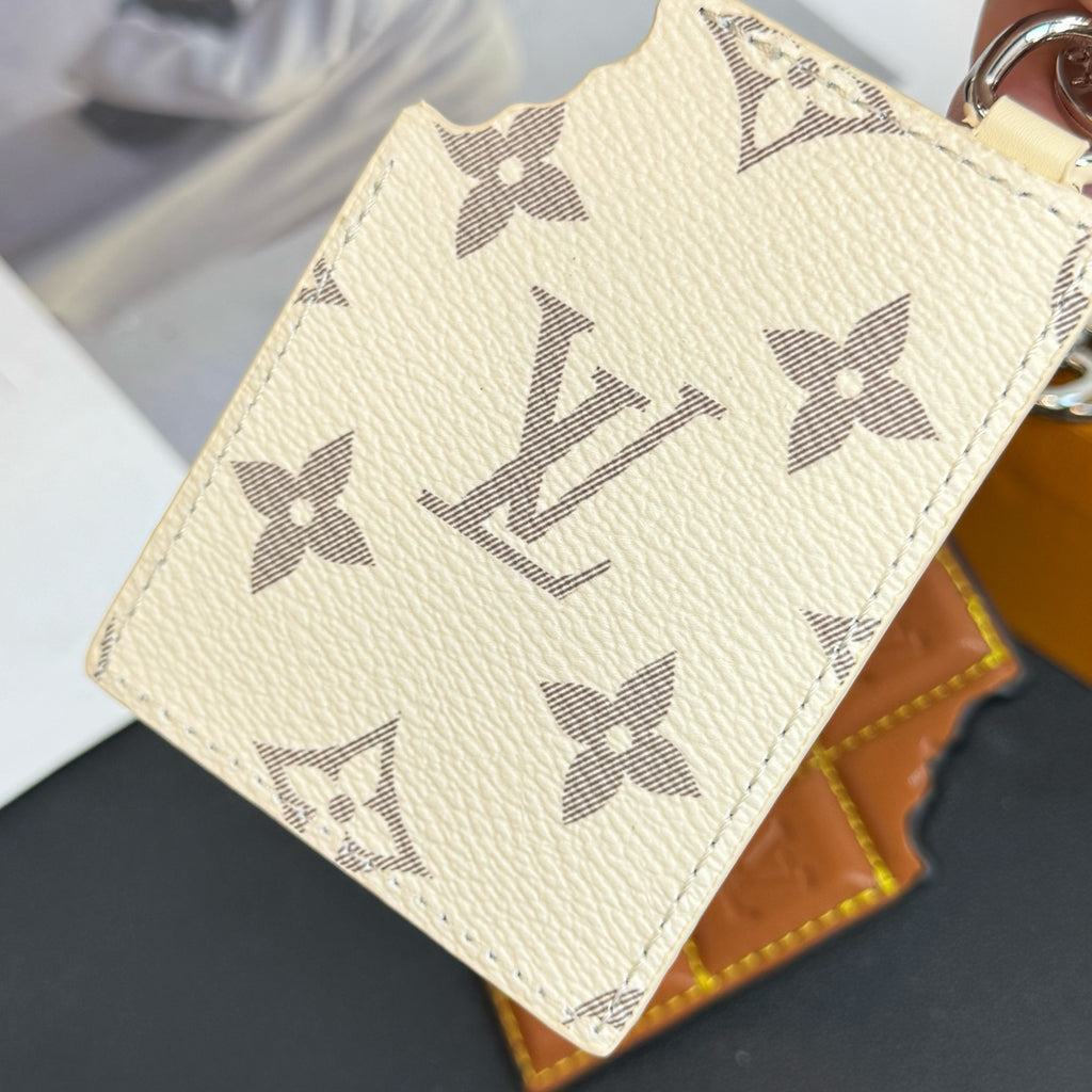 Louis Vuitton cream monogram card holder with repeating star pattern and textured leather