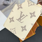 Louis Vuitton cream monogram card holder with repeating star pattern and textured leather