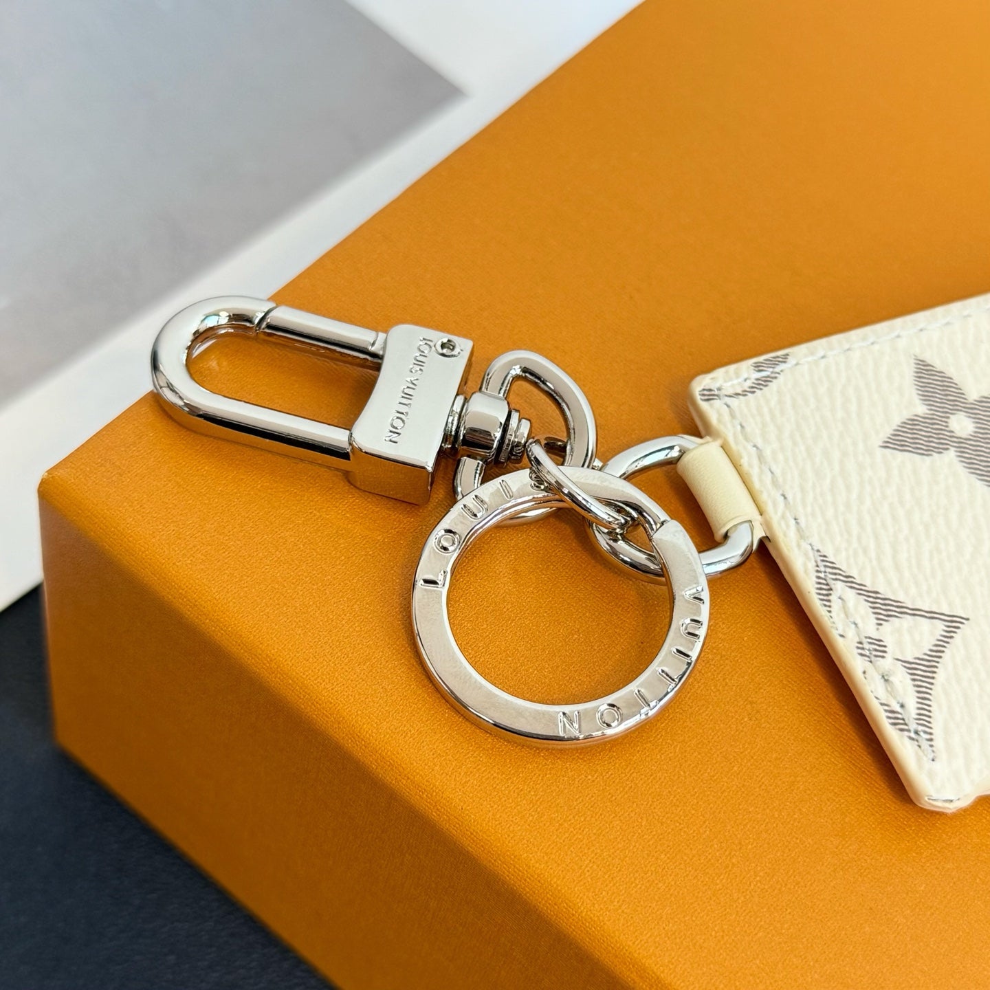 Louis Vuitton keyring hardware with cream monogram card holder attached