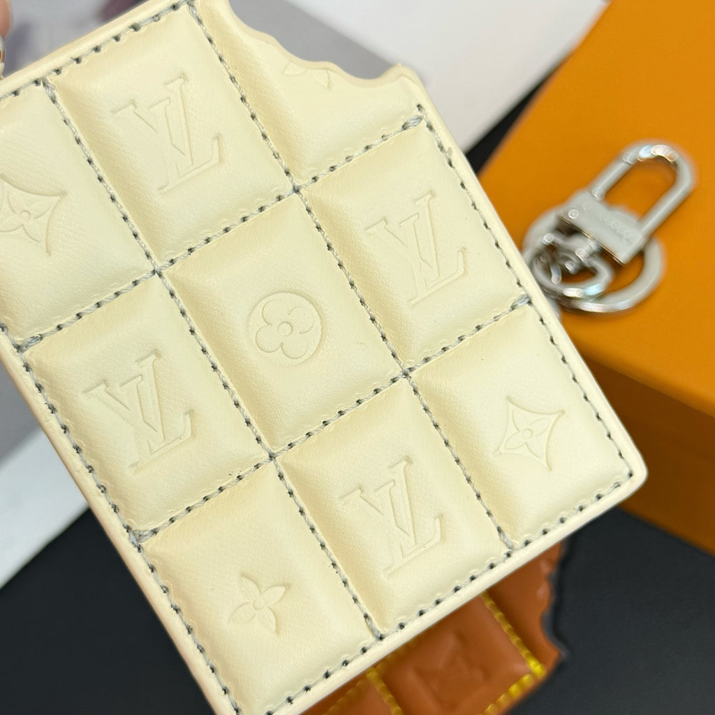 Louis Vuitton cream quilted monogram card holder close-up with stitched panels