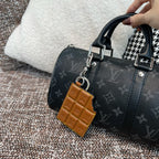 Louis Vuitton monogram handbag with tan leather key holder charm and metal ring clip