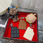 Louis Vuitton accessory set with keychains and card holders in dark and cream tones