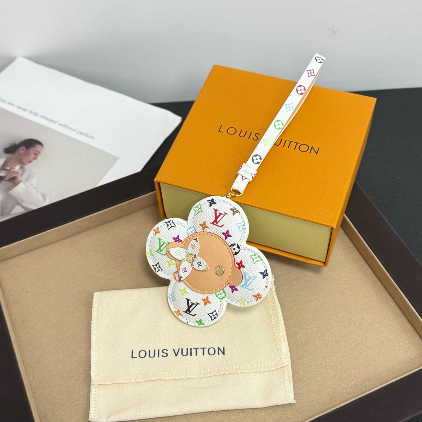 Louis Vuitton keychain: white monogram flower with dog face, logo strap