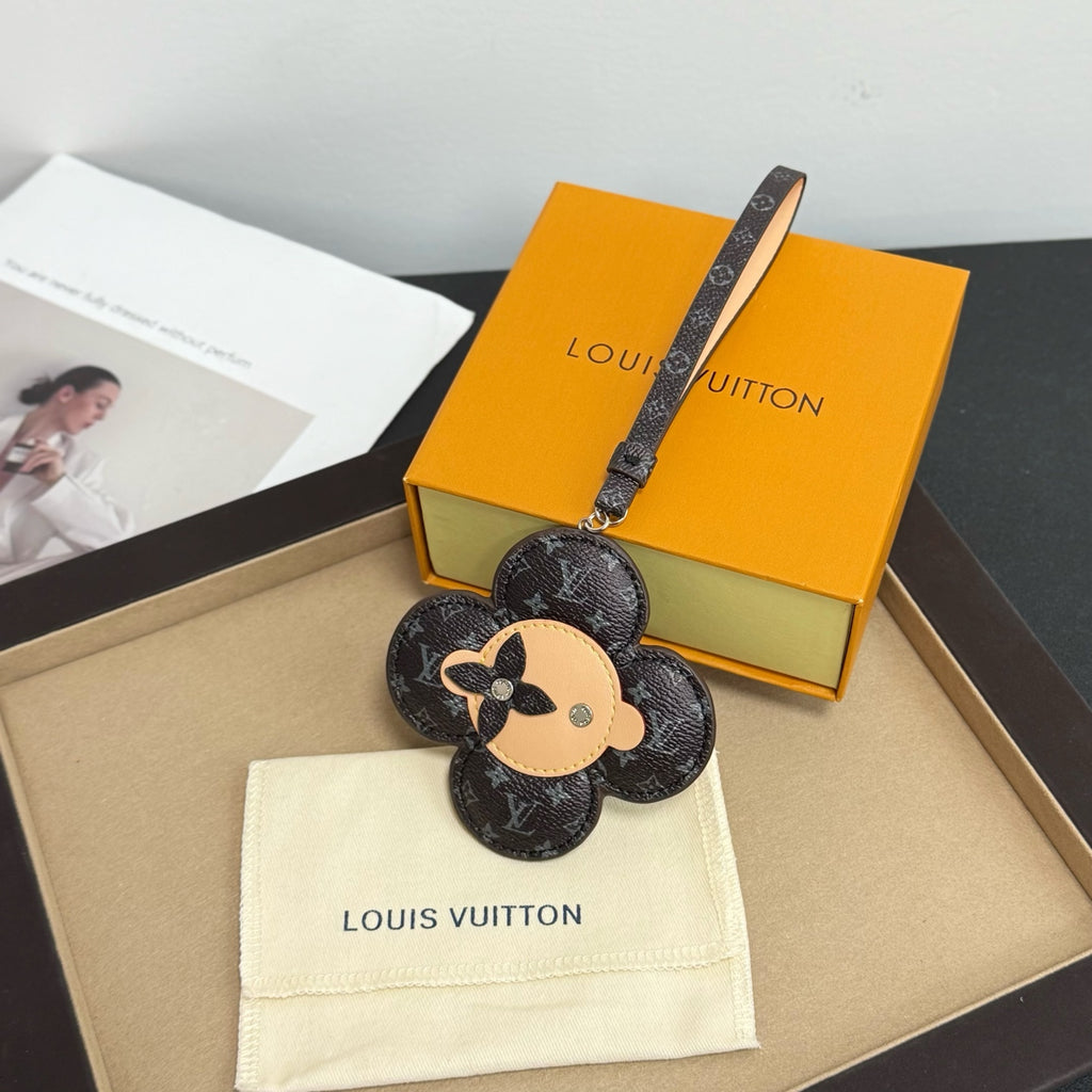Louis Vuitton keychain: black monogram flower with dog face, logo strap
