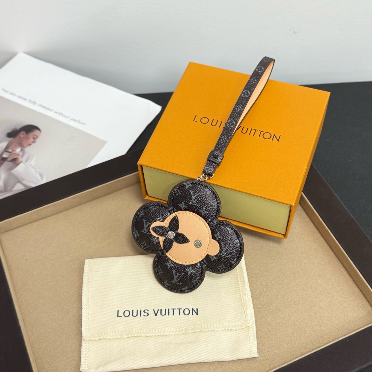 Louis Vuitton keychain: black monogram flower with dog face, logo strap