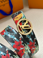 Louis Vuitton belt strap close-up with floral print and gold-tone oval LV buckle detail.