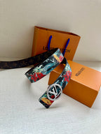 Louis Vuitton belt with floral strap and large gold-tone oval LV buckle, wide belt tail.