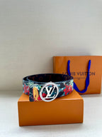 Louis Vuitton belt on display with floral strap and gold-tone oval LV buckle front.