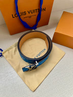 Blue monogram belt with silver LV buckle and tan leather strap, on pouch