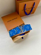 Blue monogram belt with tan leather strap and silver LV buckle, folded