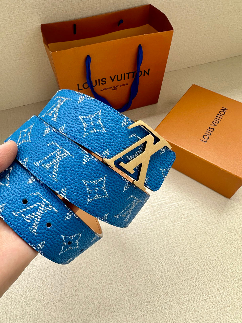 Blue monogram belt with tan leather keeper and silver LV buckle