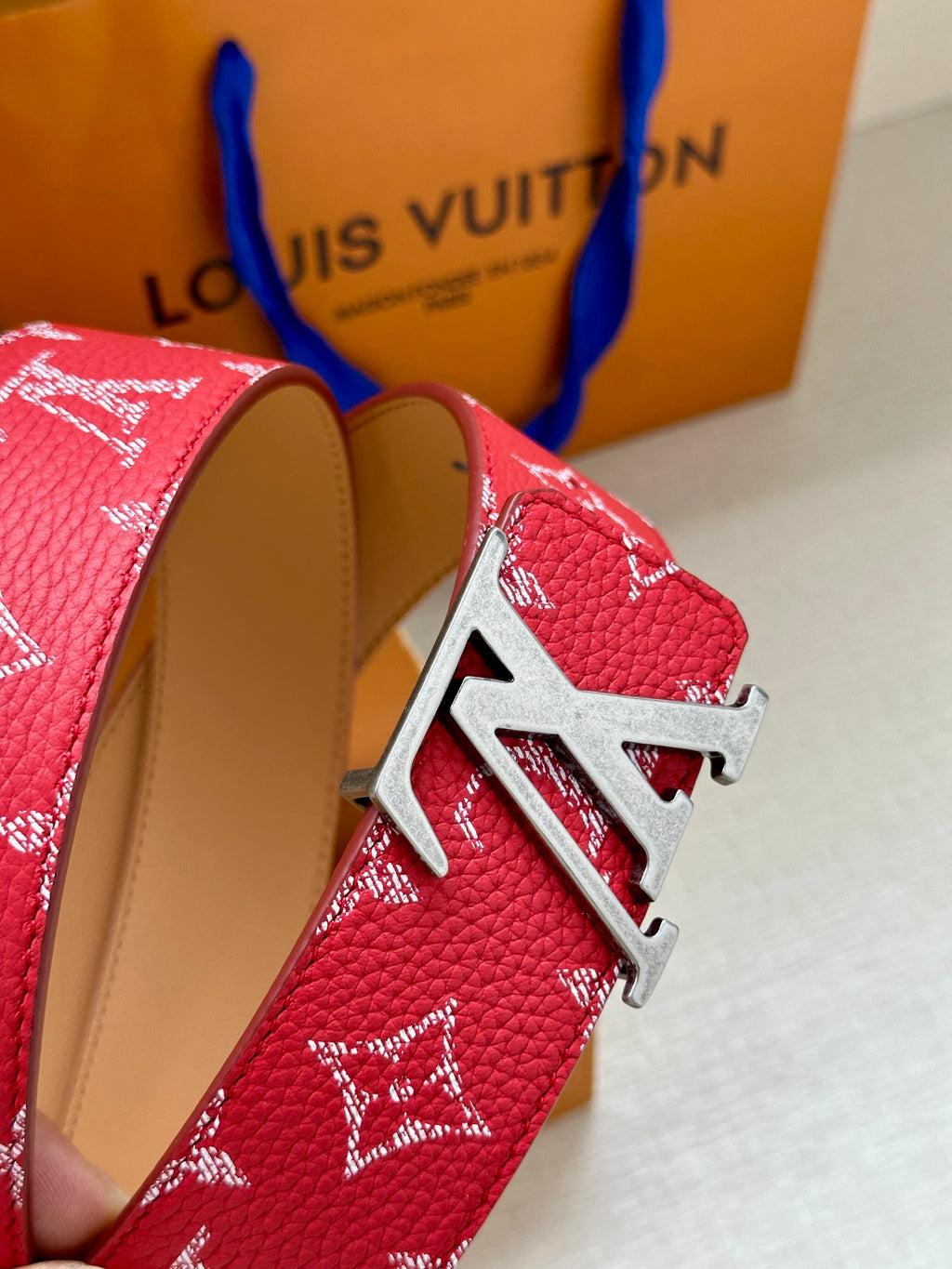 Louis Vuitton red monogram belt with silver-toned LV buckle and tan lining