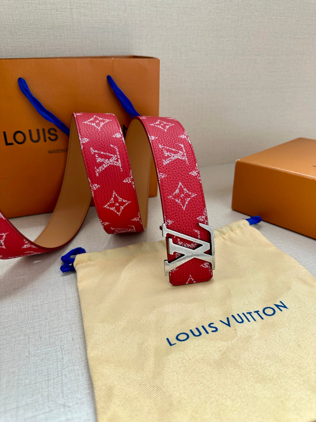 Louis Vuitton red monogram belt with silver-toned LV buckle and tan reverse