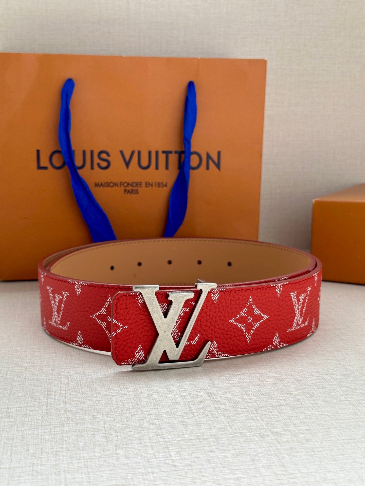 Louis Vuitton red monogram belt with silver-toned LV buckle