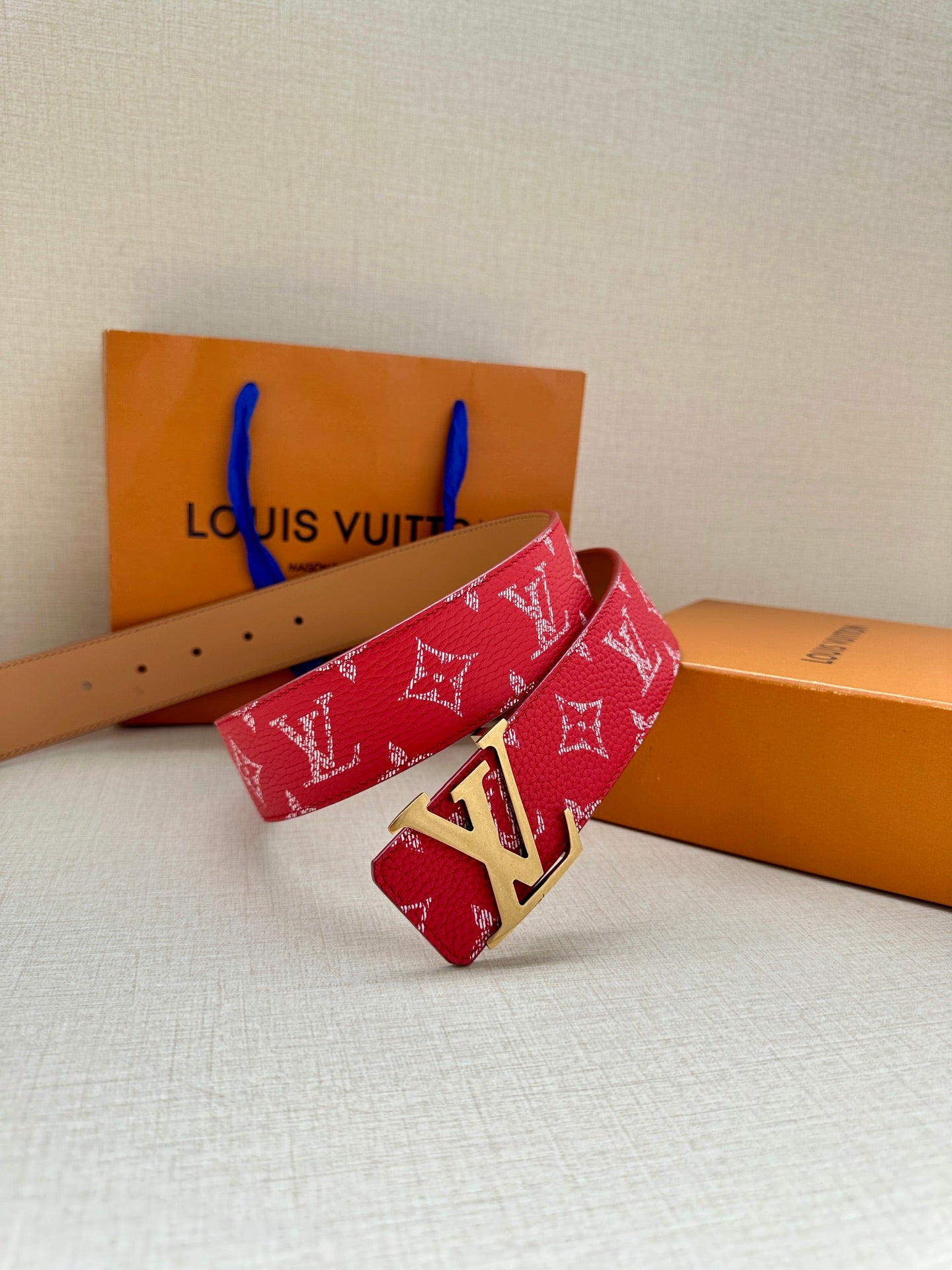 Louis Vuitton red monogram belt with gold LV buckle, folded strap