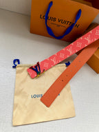 Louis Vuitton monogram belt with pink strap and gold-tone LV buckle