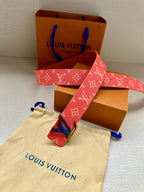 Louis Vuitton monogram belt with pink strap and gold-tone LV buckle