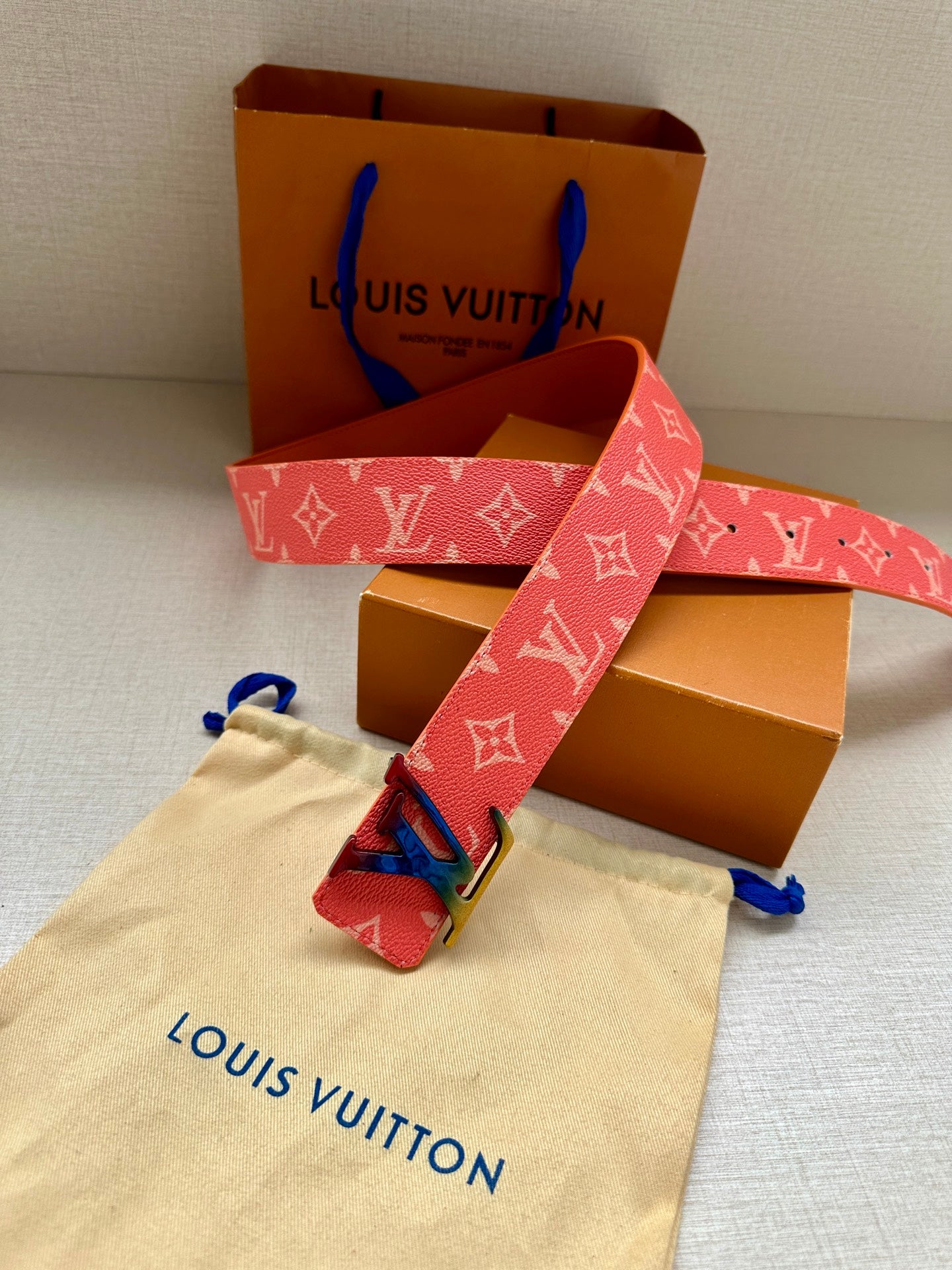 Louis Vuitton monogram belt with pink strap and gold-tone LV buckle