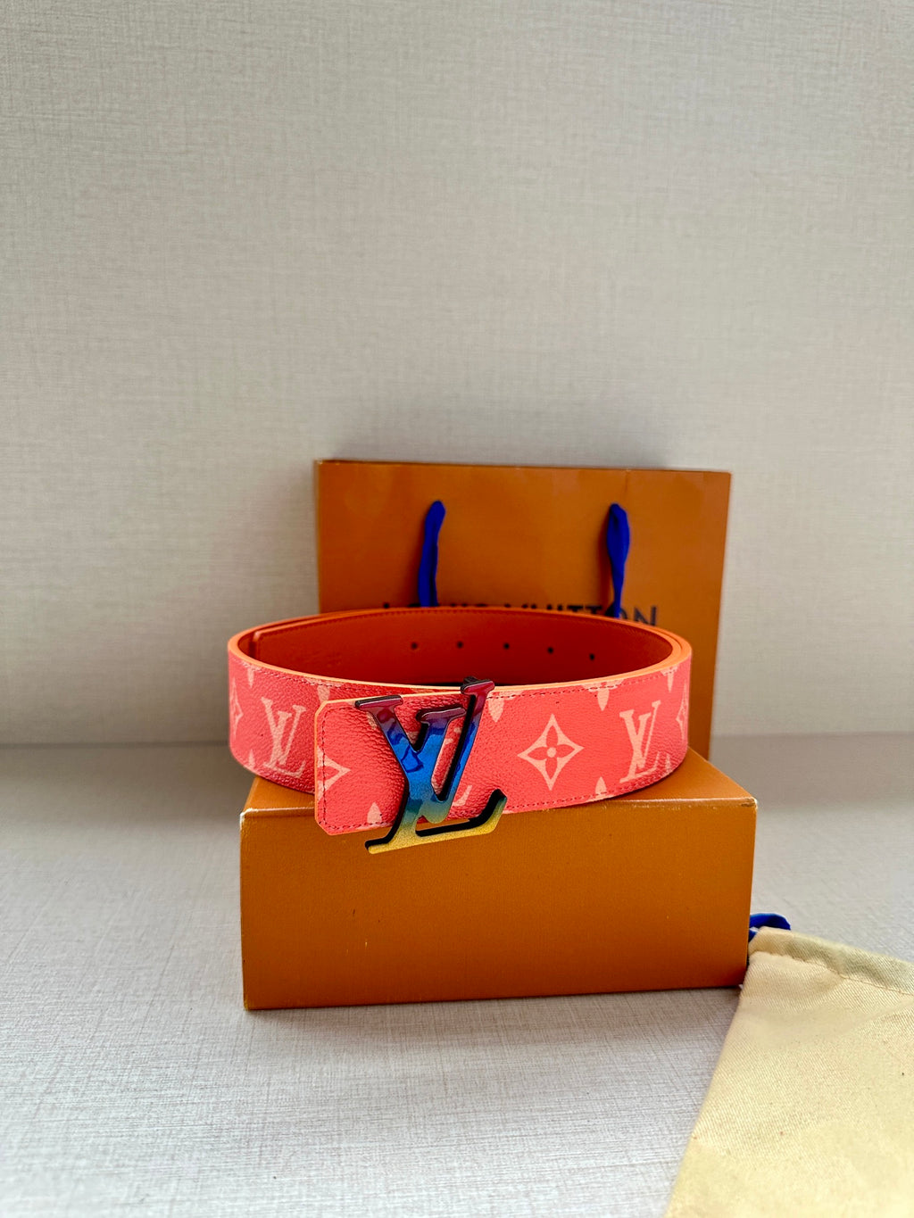 Pink Louis Vuitton monogram belt with gold LV buckle and blue accents