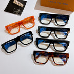 Louis Vuitton eyeglasses set with orange, blue-lensed, and tortoiseshell frames on display