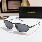 Oval dark gray tinted sunglasses with black metal frame and slim arms