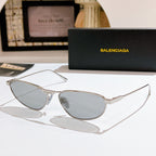 Oval light gray tinted sunglasses with silver metal frame and slim temples